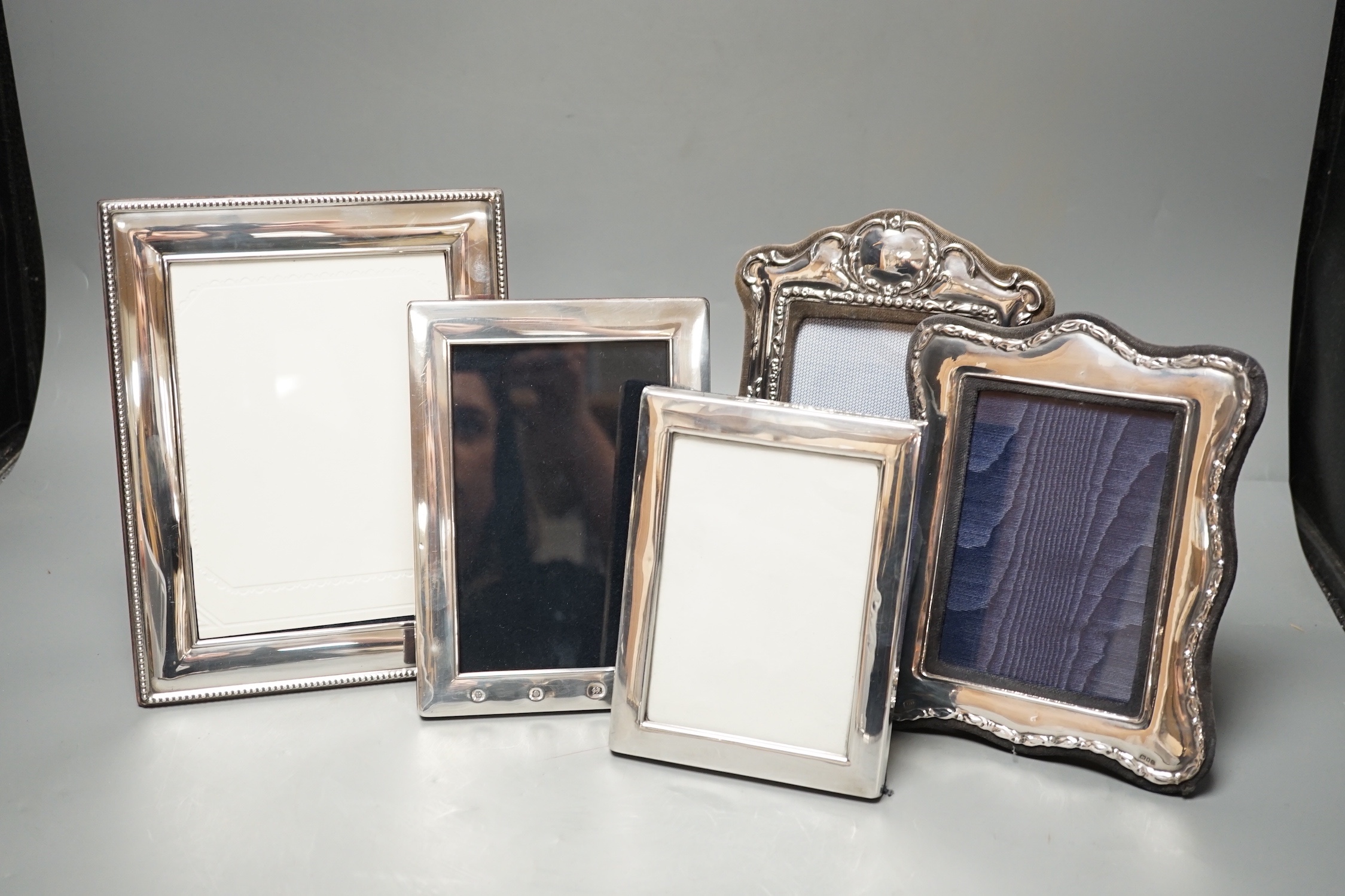 Four assorted modern silver mounted photograph frames, largest 22.2cm and an E.P.N.S. mounted photograph frame.